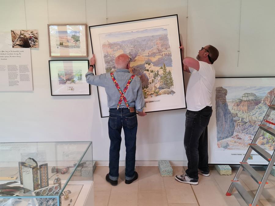 Artist Tony Foster and his technician hanging the Fragile Planet Exhibition